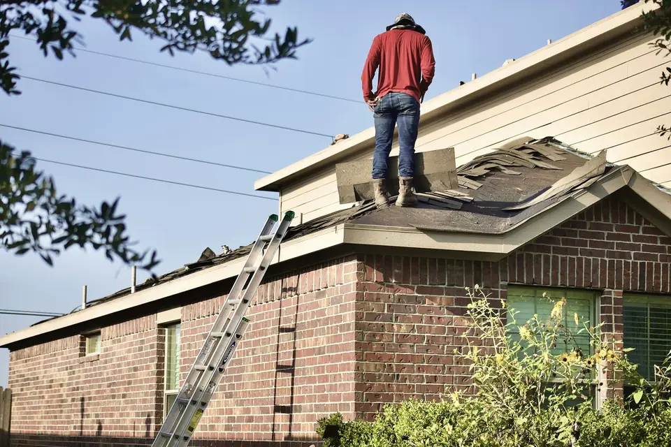 Roofer on a house roof during a tear-off